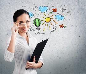 Thoughtful young businesswoman with doodles on background