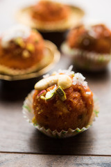 Carrot Halwa Laddu or sweet balls,  served in a plate with dry fruits toppings. selective focus