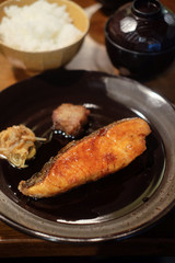 Grilled salmon fillet steak on black dish