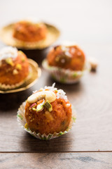 Carrot Halwa Laddu or sweet balls,  served in a plate with dry fruits toppings. selective focus
