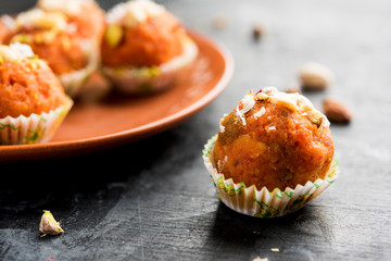 Carrot Halwa Laddu or sweet balls,  served in a plate with dry fruits toppings. selective focus