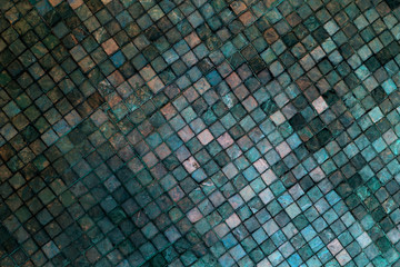 Colorful soft pastel monophonic Venetian mosaic as decorative decoration of facade. Venetian mosaic as decorative background. Selective focus. Abstract pattern. Abstract mosaic ceramic stones