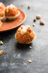 Carrot Halwa Laddu or sweet balls,  served in a plate with dry fruits toppings. selective focus