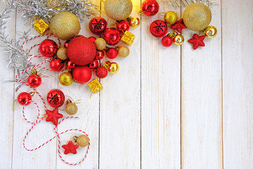 Christmas decorations, glass red and golden balls on white wooden rustic table. Christmas holiday background. Advent time, festive winter season. template for design. flat lay, copy space