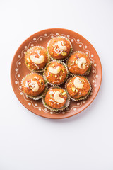 Carrot Halwa Laddu or sweet balls,  served in a plate with dry fruits toppings. selective focus