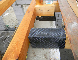 Wateproofing house roof wooden beams, trusses with bitumen material. House roofing construction.