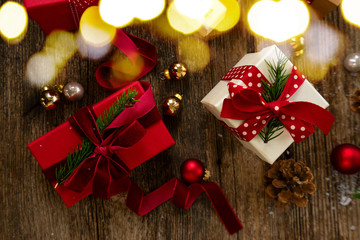 Christmas gift giving concept - christmas presents on wooden table, flat lay top view scene with bokeh lights