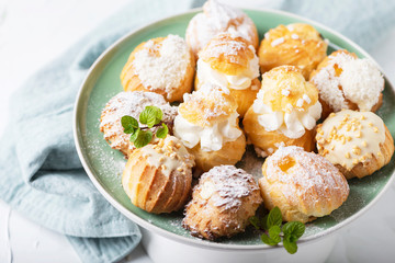 Delicious profiteroles with cream