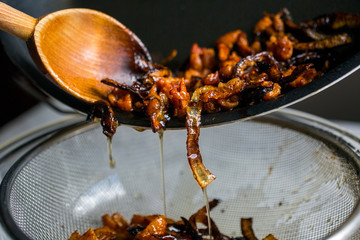 Close up of schmaltz and gribenes in frying pan