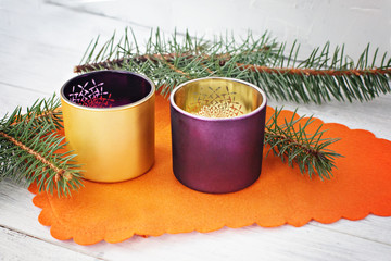 purple and gold couple candlesticks with a Christmas tree on a white wooden background