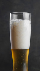Glass of lager wheat beer with foam