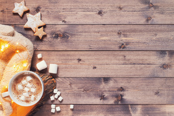 Festive wooden background with cup of cocoa with marshmallow