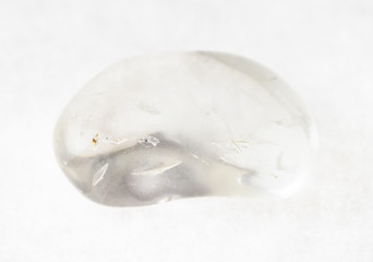 tumbled rock crystal ( quartz) stone on white