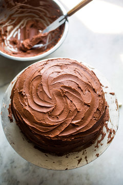 Close up of devil's food cake with black pepper buttercream on cake stand