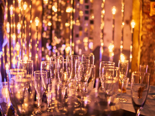 New years eve festive celebration blurry background with glasses of champagne. Vintage gold Fireworks and bokeh in New Year eve and copy space. holiday background