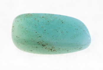 polished aquamarine (blue beryl) stone on white