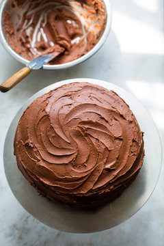 Close up of devil's food cake with black pepper buttercream on cake stand