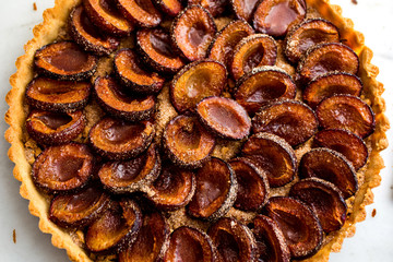 Close up of baked plum tart on table