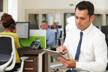Businessman Using Digital Tablet In Modern Office