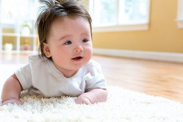 Fototapeta premium Happy baby boy lying down and resting