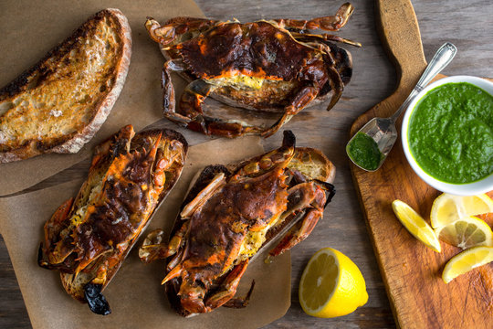 Close up of soft shell crab toasts served with green sauce