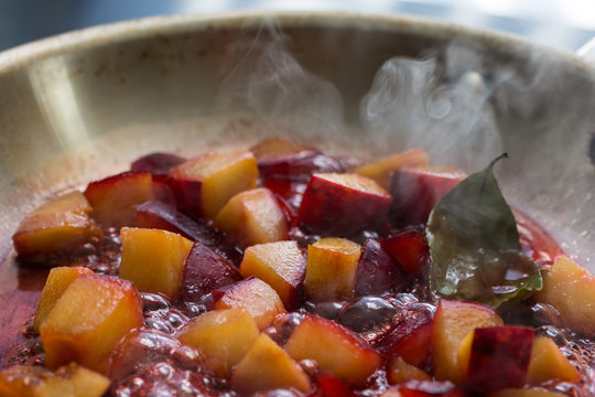 Close up of plum cooking in saucepan