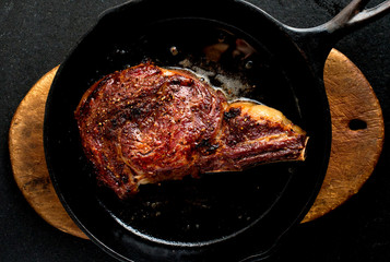 Close up of rib eye steak in frying pan