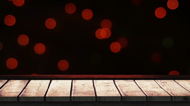 Wooden foreground with Christmas background of lights