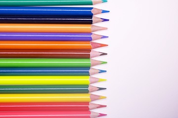 Fototapeta premium Colorful pencils on white background with copy space
