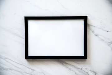 Black frame with white space for text on marble background