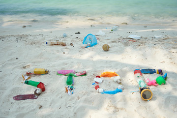 The Word Stop Written With Washed Up Plastic Debris On A White Beach In The Maldives. Ecological Message To The World.