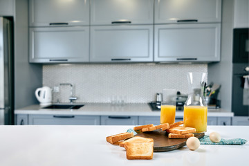 Fototapeta na wymiar Continental breakfast - orange juice and toast on white table.