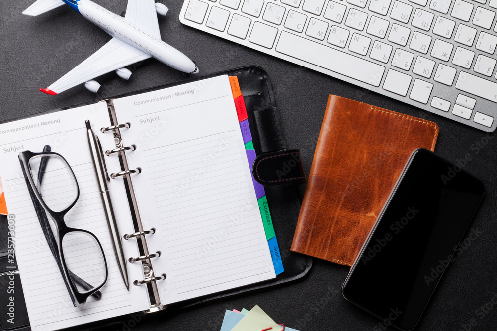 Wall mural Business trip concept. Accessories on desk table