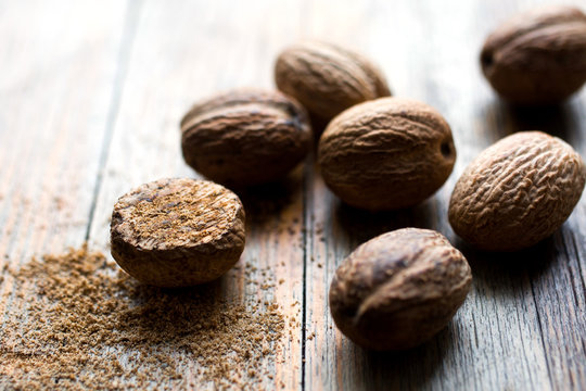 Close up of nutmeg on wooden table