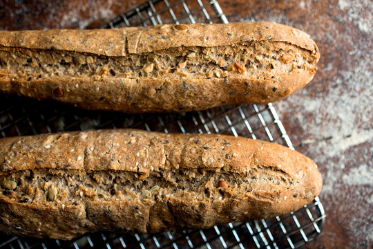 Close up of whole wheat seeded loaves on cooling rack