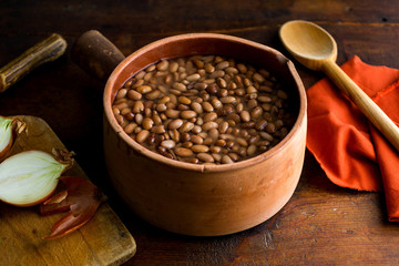 Close up of pinto beans soaked in a bowl of water