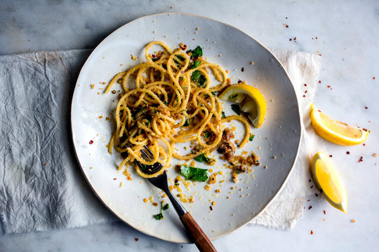 Overhead View Of Pasta With Garlicky Breadcrumbs And Anchovies Serve On Plate