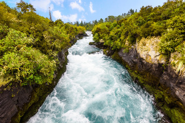 The powerful force of flowing and raging water of the Waikato River. Landscape at Huka Falls near Taupo, North Island, New Zealand.