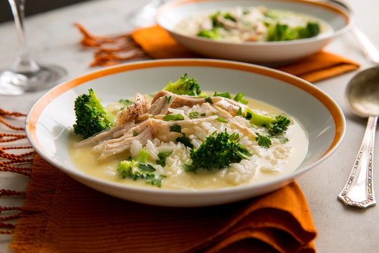 Close Up Of Egg Lemon Soup With Turkey And Broccoli Served On A Plate