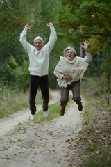 Fototapeta premium Portrait of cute old couple at park
