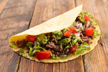traditional taco with minced beef, avocado and salad