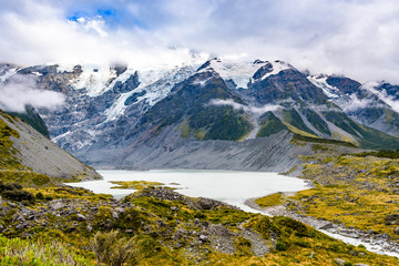 Fototapeta na wymiar Amazing beautiful landscape at Hooker Valley Track, a breathtaking place in Aoraki, New Zealand. It is a famous tourist attraction surrounded by alpine mountain meltwater streams, glacier and lakes.