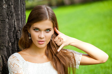 Naklejka premium Beautiful woman making a call me gesture