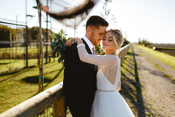 Bride and groom walk through the park in the city of Ravenna.