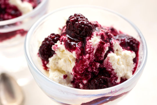 Close up of blackberry compote on ricotta served in glass