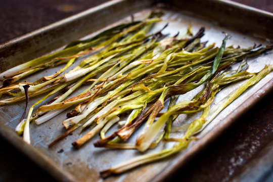 Close up of roasted scallions in baking tray