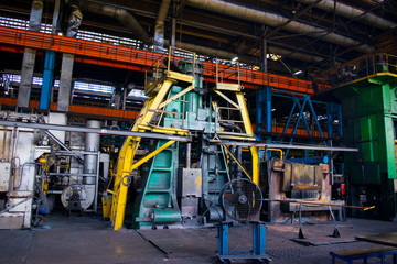 Fototapeta na wymiar Large pressing machine in the industrial shop forging plant. Press, machine for stamping iron and cast iron metal products.