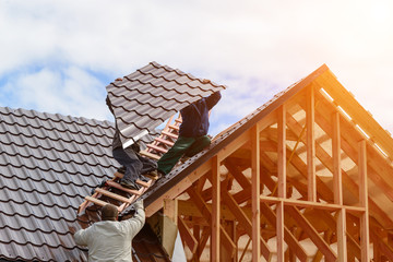 Masters make the roof of the frame house, metal on the roof of a new house © smspsy