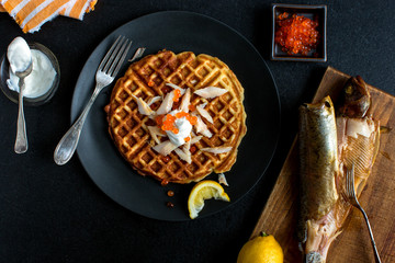 Overhead view of potato waffles with smoked trout