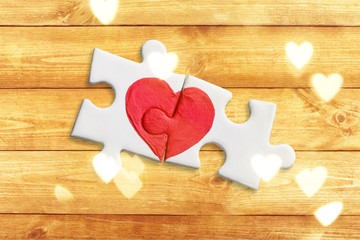 Puzzle pieces with painted red heart